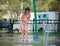 Child girl playing in kids outdoor water park