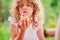 Child girl playing with salt dough cake decorated with flower