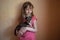 Child girl plays with little dog black hairy chihuahua doggy