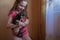 Child girl plays with little dog black hairy chihuahua doggy