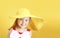 Child girl portrait on yellow background,summer design vocation concept.Empty space