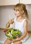 Child girl preparing salad