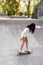 Child girl ride on skate board on sport ramp. Sports equipment for kids. Active teenager with skateboard on skate park