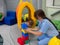 Child girl in roller tonnel during sensory integration session