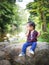 Child girl scared sitting on a rock