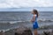 Child girl on the sea before the storm, strong wind