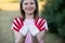 Child girl show hands painted in Indonesia flag colors, focus on hands. Indonesian patriotism concept. Indonesian