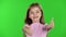 Child girl showing thumbs up. Green screen. Slow motion