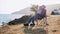 Child girl sits on the father`s knees while they rest at campsite on lake shore