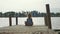 Child girl sits on the wood pier in lotus pose and meditate in slow motion