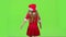 Child girl is spinning in her New Year`s costume. Green screen. Slow motion