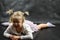 Child girl upset lying on the floor and crying on a black background