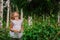 Child girl on the walk in summer forest, nature exploration with kids