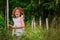 Child girl on the walk in summer forest, nature exploration with kids