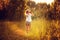 Child girl watching birds with binoculars in summer