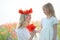 child giver flowers to his mom. Outdoors family portrait daughter with mother