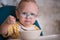 Child with glasses eating porridge