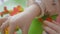 Child glues curly paper in leaf shape