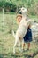 Child and a goat in the countryside