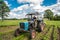 child and grandpa on a tractor rural village countryside