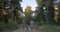 Child and grandparents running in the forest