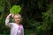 Child with green burdock leaf