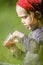 Child in green wild meadow eating wild strawberries. Summer happy times.