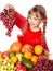 Child with group fruit and vegetable.