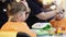 Child hairstyle. Hairdresser working with small boy in barbershop