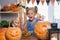 Child on a Halloween feast with pumpkins