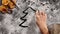 Child hand drawing a christmas tree in the flour