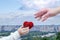 A child hand is giving a knitted heart to a female hand