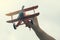 Child hand holding wooden handmade airplane