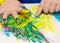 Child hand painted in colorful paits. Education, school, creativity and painting concept.