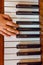 Child hand on the shiny piano keys. Top view