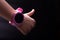 Child hand with thumb up. Littl hand with pink smart watch on black