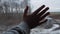 Child hand on the train window on the background of landscape, snow covered field and trees.