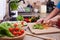 Child hands chopping vegetables on cutting board - the lettuce l