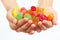 Child hands with colorful fruity sweets and jelly close up