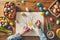 Child hands create Easter crafts is surrounded by festive array of colorful eggs