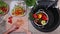 Child hands cutting cherry tomatoes - top view