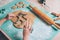 Child hands cutting cookies from fresh dough and baking gingerbread Christmas biscuits at the kitchen. Genuine moments