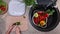 Child hands cutting cucumber for a vegetables salad