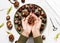 Child hands hold a chestnut for making autumn decor. Creative crafts with natural material.