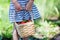 Child hands holding basket full of strawberries at pick your own farm.