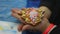 Child hands holding little ginger cookie in the shape of Christmas tree