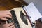 Child hands on keyboard of old portable typewriter