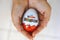 Child hands with Kinder Surprise egg