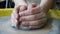 Child hands making clay pottery