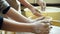 Child hands making clay pottery